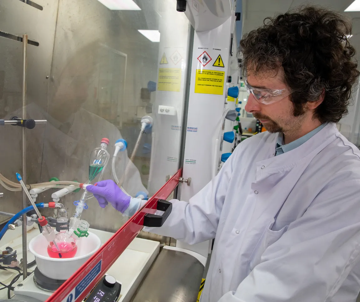 PR&D chemist with glassware setup